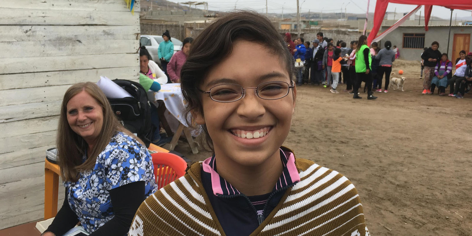 Smiling girl in Ecuador wearing new eyeglasses provided by God’s Eyes vision clinic.