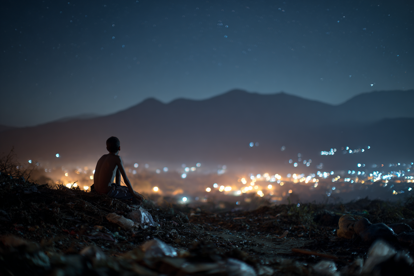 A young boy standing on a trash dump, gazing up at the night sky filled with stars – inspired by a real mission story from Bryan Kaiser’s They Shall See God.